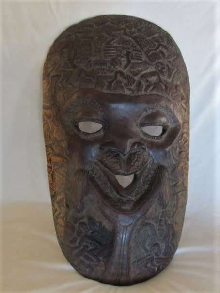 AN UNUSUAL VERY LARGE INTRICATELY CARVED WOODEN AFRICAN MASK