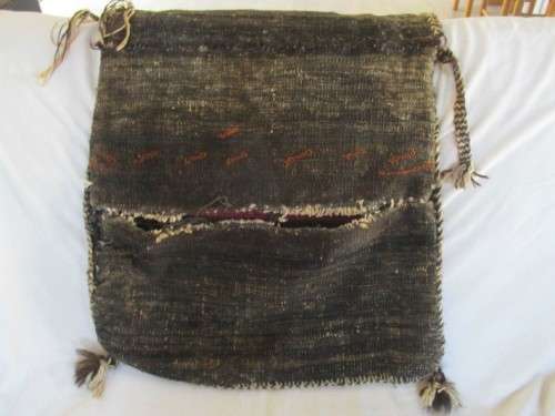 A VINTAGE/ANTIQUE HAND WOVEN MIDDLE EASTERN CAMEL SADDLE BAG IN NEED OF TLC