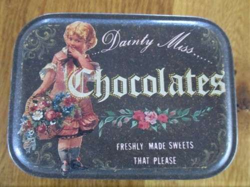 A VINTAGE "DAINTY MISS CHOCOLATES" TIN FILLED WITH OVER A HUNRED OLD 1/2 CENT COINS (LARGER SIZE)