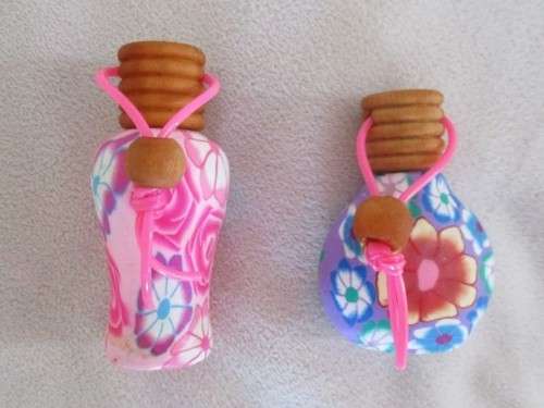 TWO PRETTY PERFUME BOTTLES WITH WOODEN LIDS TO ADD TO YOUR COLLECTION