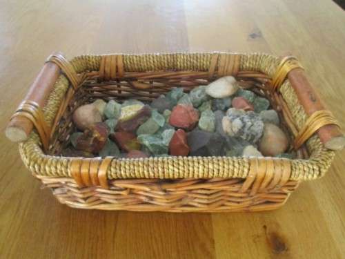 AN OLD BASKET FULL OF OVER EIGHTY ROUGH GEMSTONE ROCKS AND CRYSTALS