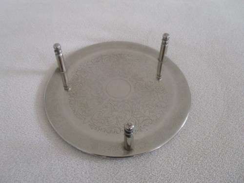 A SET OF SEVEN ETCHED SILVER METAL COASTERS WITH STAND