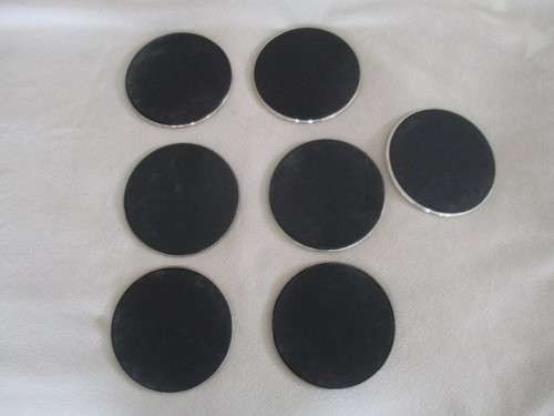 A SET OF SEVEN ETCHED SILVER METAL COASTERS WITH STAND