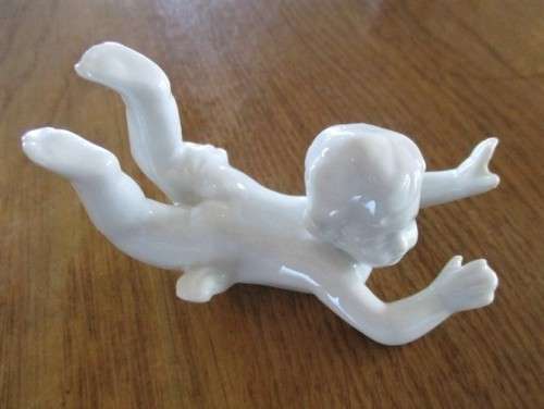 TWO VINTAGE PORCELAIN FROLICKING CHILDREN