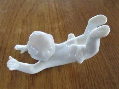 TWO VINTAGE PORCELAIN FROLICKING CHILDREN