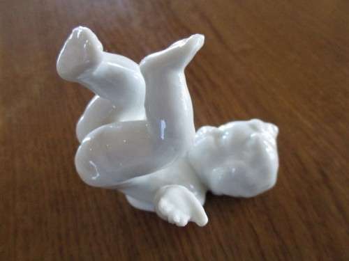 TWO VINTAGE PORCELAIN FROLICKING CHILDREN
