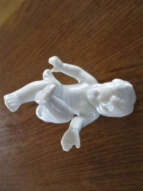 TWO VINTAGE PORCELAIN FROLICKING CHILDREN