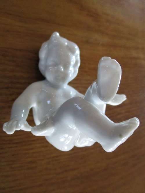 TWO VINTAGE PORCELAIN FROLICKING CHILDREN