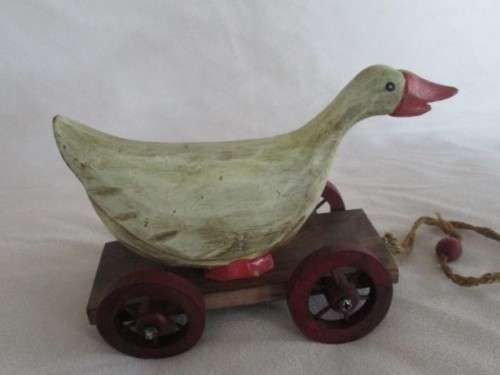 A VERY OLD VINTAGE PULL ALONG WOODEN DUCK