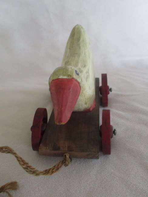 A VERY OLD VINTAGE PULL ALONG WOODEN DUCK