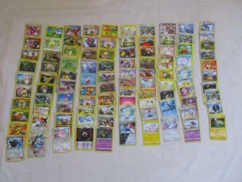 ONE BID FOR ALL - OVER 1200 POKEMON CARDS WITH 66 FOIL, 77 HOLO, 1 "REDEEM YOUR REWARDS", AND 5 TINS