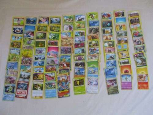 ONE BID FOR ALL - OVER 1200 POKEMON CARDS WITH 66 FOIL, 77 HOLO, 1 "REDEEM YOUR REWARDS", AND 5 TINS