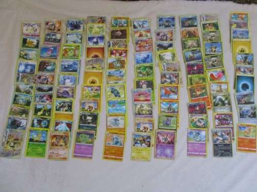 ONE BID FOR ALL - OVER 1200 POKEMON CARDS WITH 66 FOIL, 77 HOLO, 1 "REDEEM YOUR REWARDS", AND 5 TINS