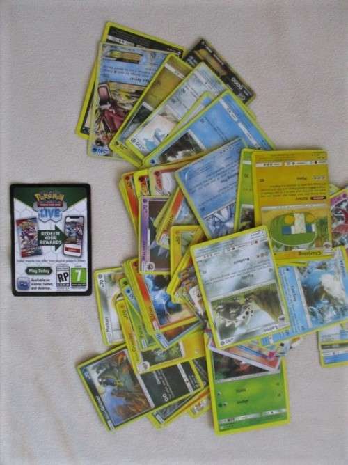 ONE BID FOR ALL - OVER 1200 POKEMON CARDS WITH 66 FOIL, 77 HOLO, 1 "REDEEM YOUR REWARDS", AND 5 TINS