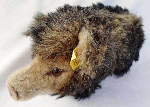 A  VINTAGE AND COLLECTABLE STEIFF 'WUTZI' WILD BOAR IN EXCELLENT CONDITION WITH BUTTON AND CHEST TAG