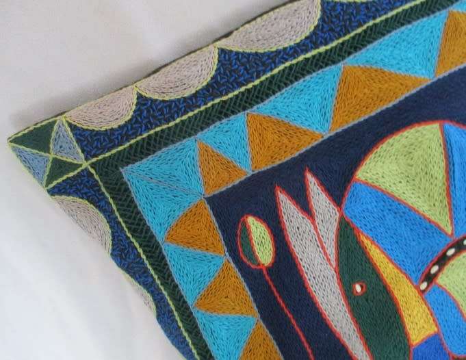 A COLOURFUL EMBROIDERED/WOVEN INDIAN CUSHION WITH ELEPHANT DESIGN