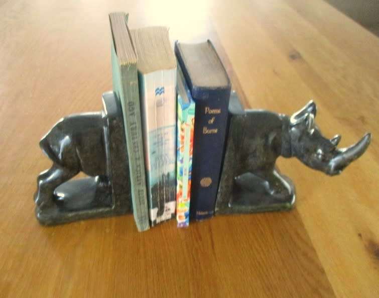 A PAIR OF HEAVY HAND CARVED STONE RHINO BOOK ENDS