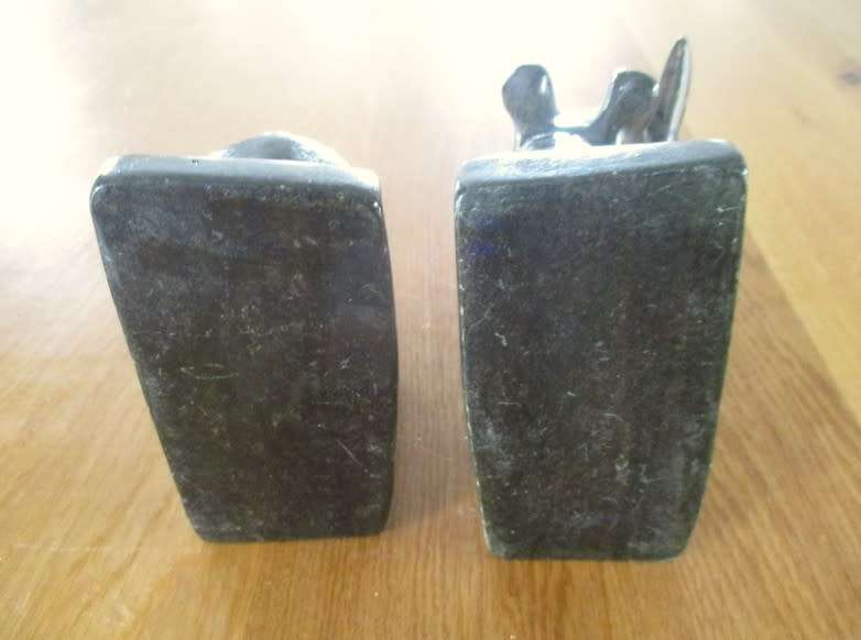 A PAIR OF HEAVY HAND CARVED STONE RHINO BOOK ENDS