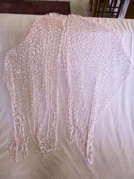 A DELICATE, FEMININE POWDER PINK SHAWL WITH LONG TASSELS AND SILVER STRANDS