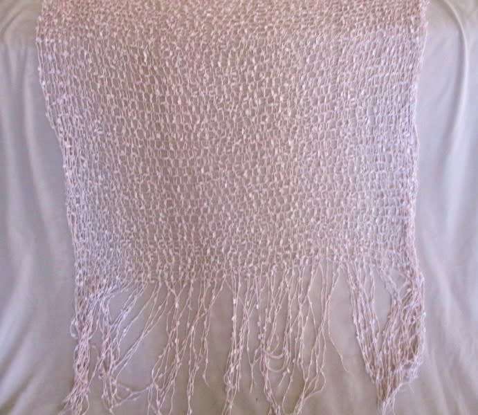 A DELICATE, FEMININE POWDER PINK SHAWL WITH LONG TASSELS AND SILVER STRANDS