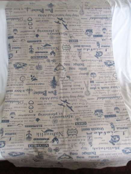 A very large, very long, wide table runner with South African scenes, songs and sayings