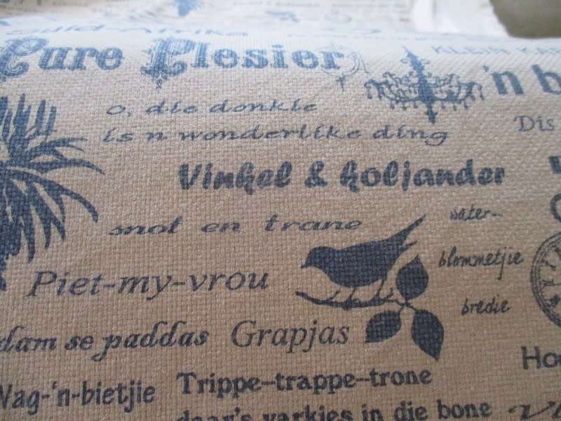 A very large, very long, wide table runner with South African scenes, songs and sayings