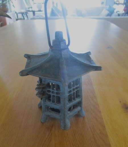 A vintage Japanese cast iron pagoda candle lantern for garden or patio