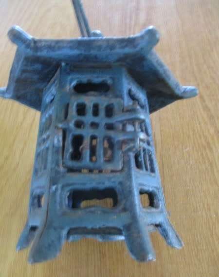 A vintage Japanese cast iron pagoda candle lantern for garden or patio