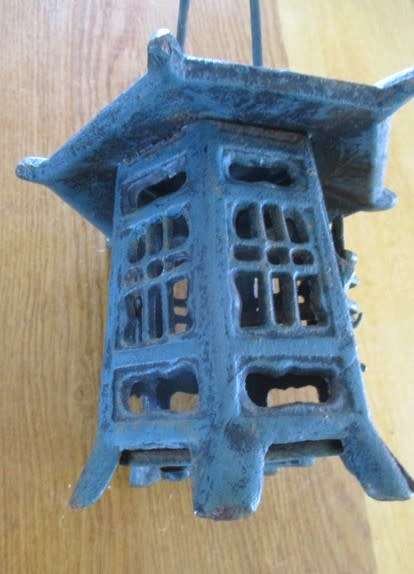 A vintage Japanese cast iron pagoda candle lantern for garden or patio