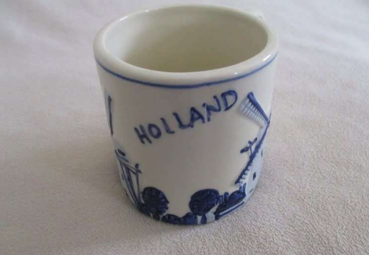 A blue and white Trophee coffee cup made in Holland