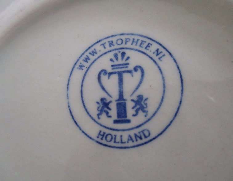 A blue and white Trophee coffee cup made in Holland