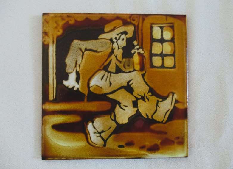 A vintage 1960`s hand painted and glazed Liebermann tile of a man with his bottle - discontinued