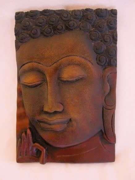 Beautiful carved wooden plaque of Buddha