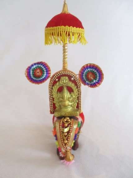 Colourful figurine of Ganesha on hand carved wooden elephant