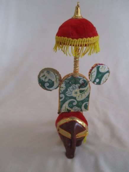 Colourful figurine of Ganesha on hand carved wooden elephant