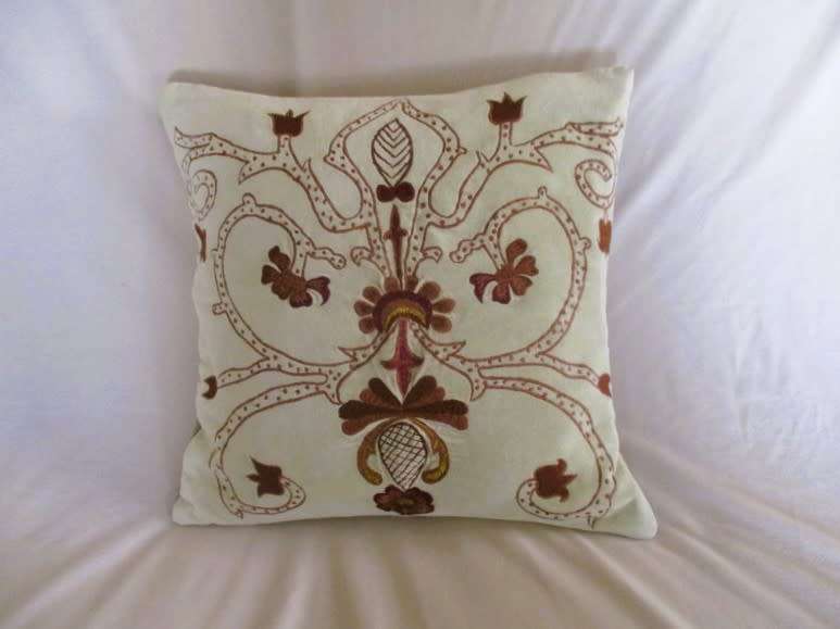 A beautifully embroidered velvet and satin cushion