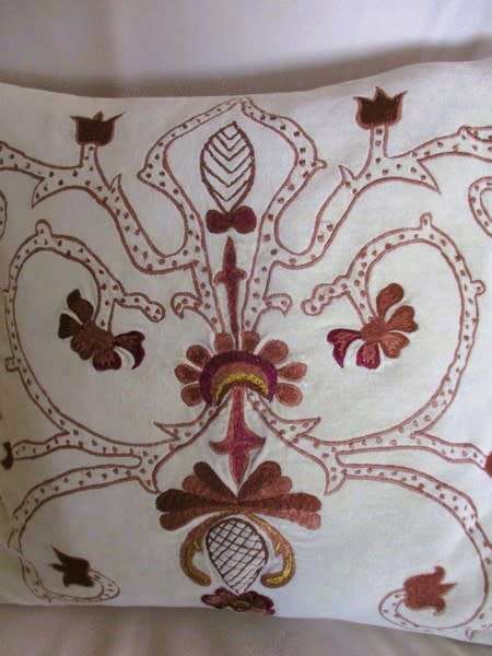 A beautifully embroidered velvet and satin cushion