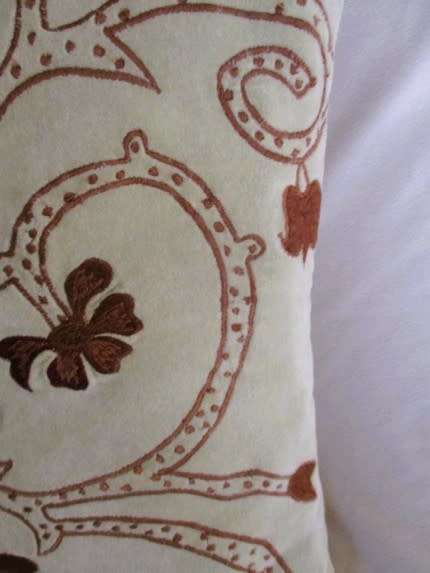 A beautifully embroidered velvet and satin cushion