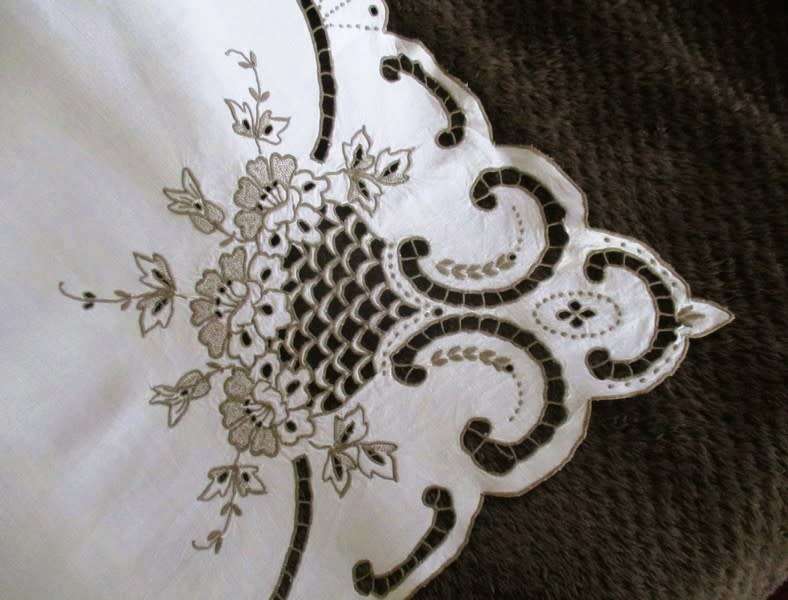 A medium-sized vintage cutwork embroidery cloth from Madeira with floral and butterfly wings detail