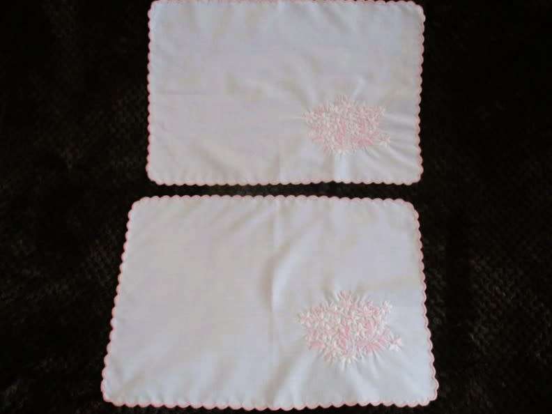 Two pretty white cloths embroidered with pink flowers
