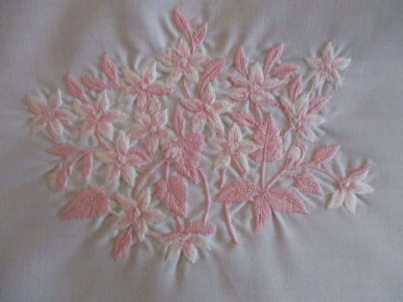 Two pretty white cloths embroidered with pink flowers