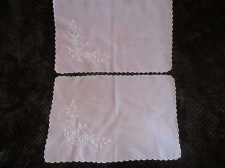 Two pretty pink cloths embroidered with white flowers