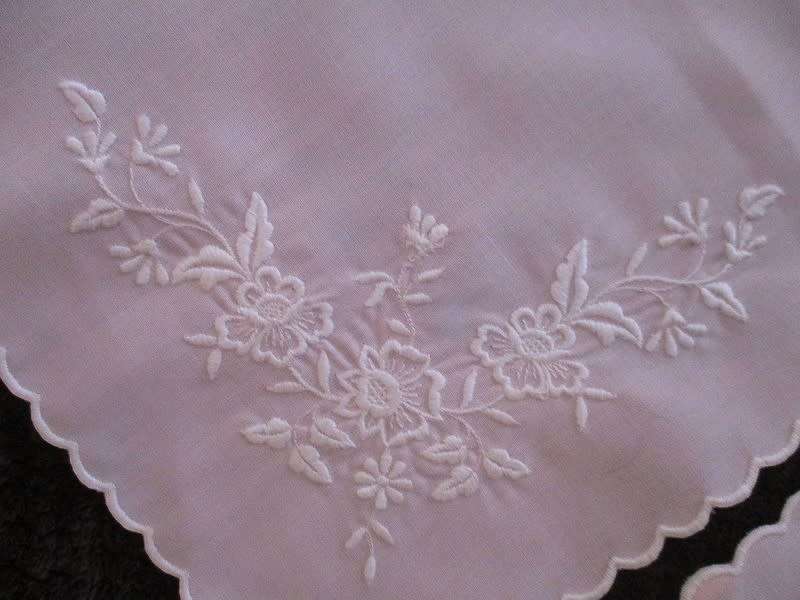 Two pretty pink cloths embroidered with white flowers