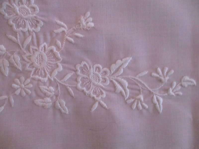 Two pretty pink cloths embroidered with white flowers