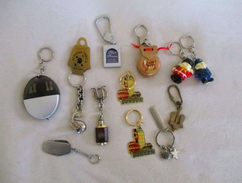 A lot of twelve interesting keyrings - perfume bottle, knife, mini tools, castanets etc