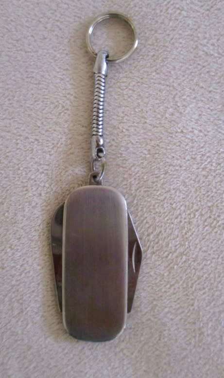 A lot of twelve interesting keyrings - perfume bottle, knife, mini tools, castanets etc