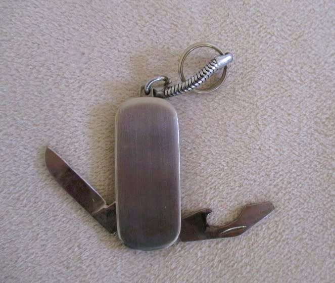 A lot of twelve interesting keyrings - perfume bottle, knife, mini tools, castanets etc