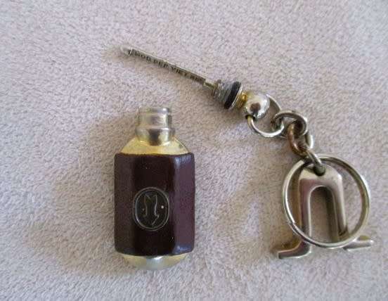 A lot of twelve interesting keyrings - perfume bottle, knife, mini tools, castanets etc