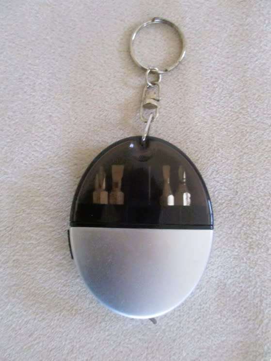 A lot of twelve interesting keyrings - perfume bottle, knife, mini tools, castanets etc
