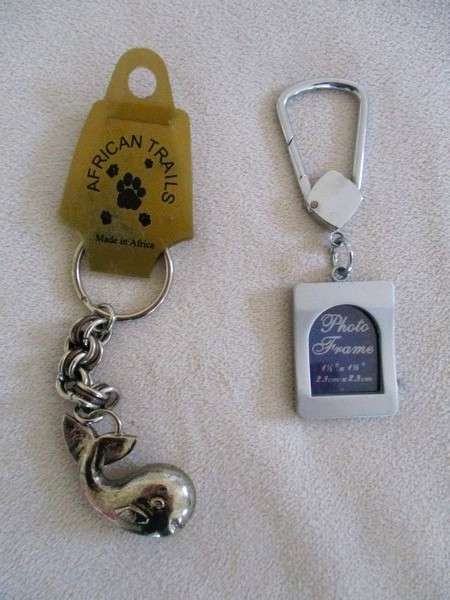 A lot of twelve interesting keyrings - perfume bottle, knife, mini tools, castanets etc